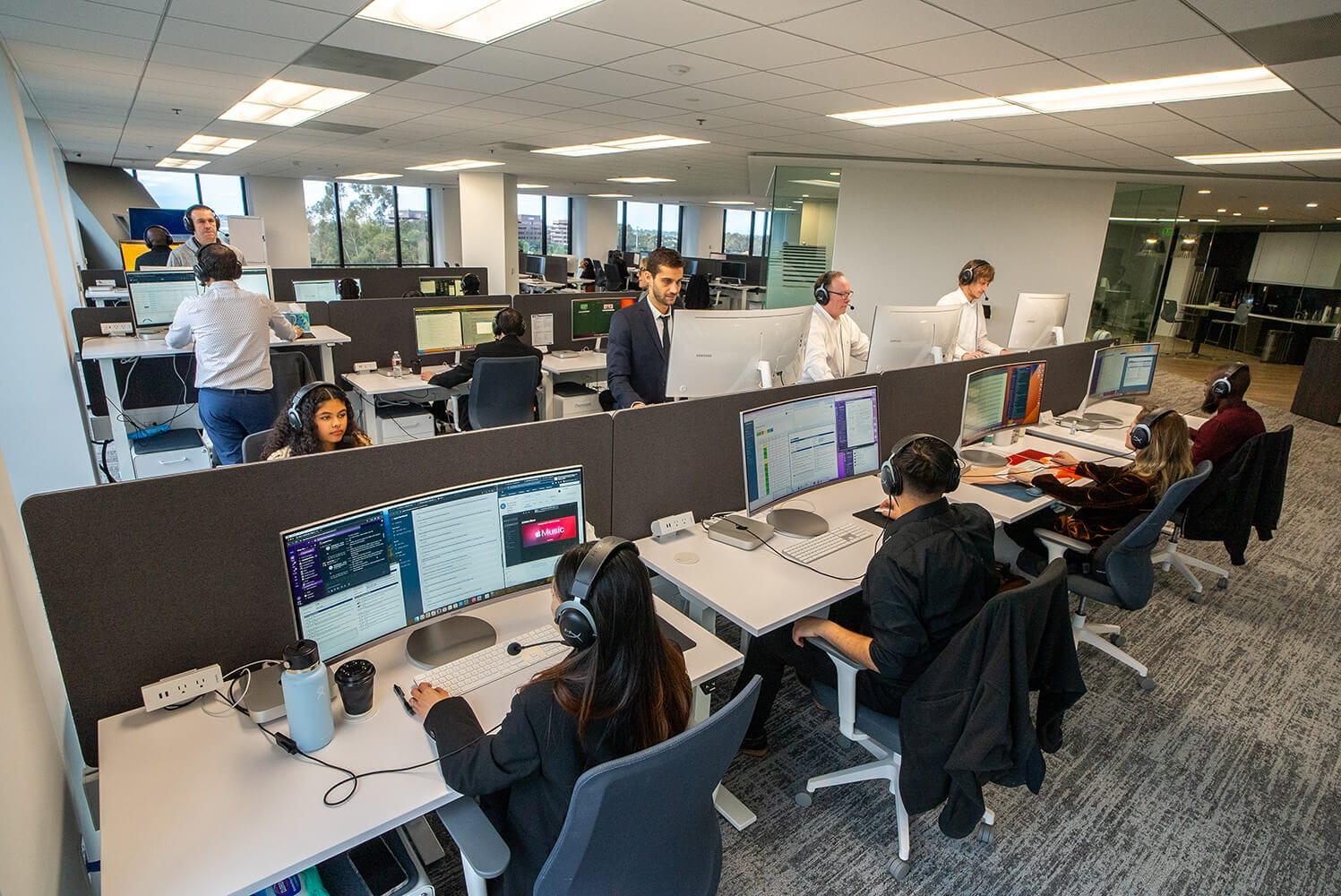 Intake specialists wearing headsets at their workstations in the Mass Tort Strategies call center